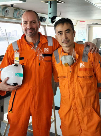 Two maritime workers on a ship.