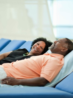 Two cruise passengers recline happily.