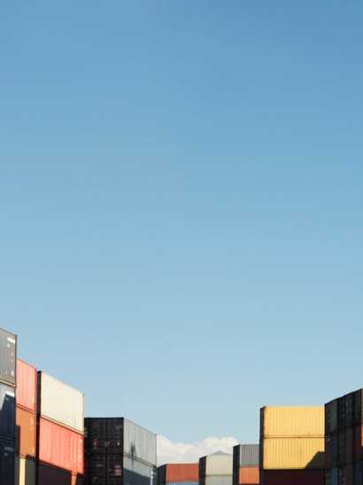 Sun shines on a shipping container yard.