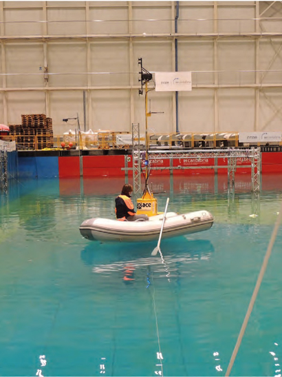 A technician prepares the scaled unit for the tank tests