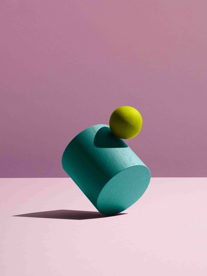 Balancing shapes, pink backdrop.